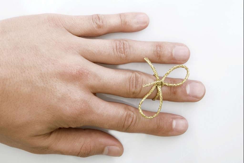 hand-with-bow-tied-around-finger-to-remember