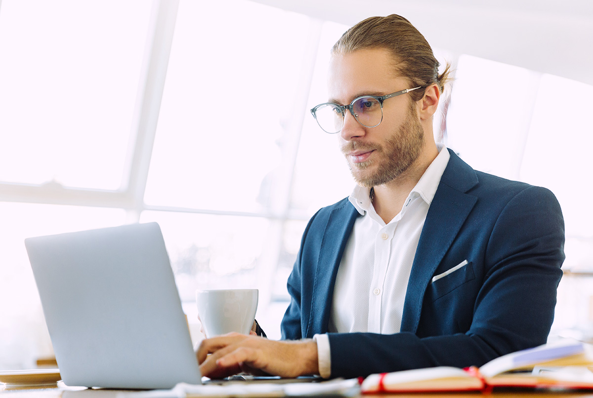 Professional working on laptop in modern office